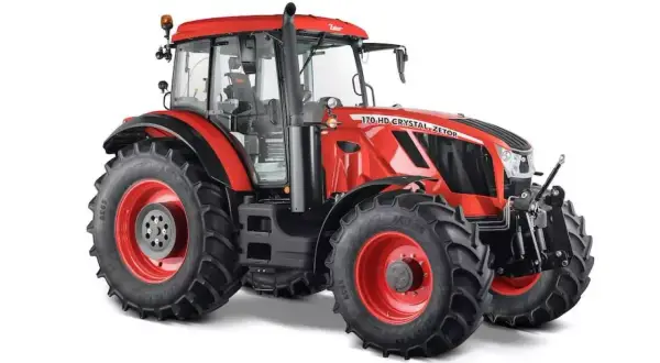 Czerwony ciągnik Zetor Crystal 170 HD z dużymi, terenowymi oponami i kabiną.