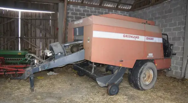 Prasa do siana Greenland CB8080 w stodole. Zastanawiasz się, ile waży bela siana? Ta maszyna pomoże Ci to ustalić.